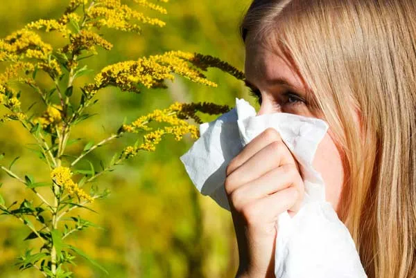 Woman with allergy in field